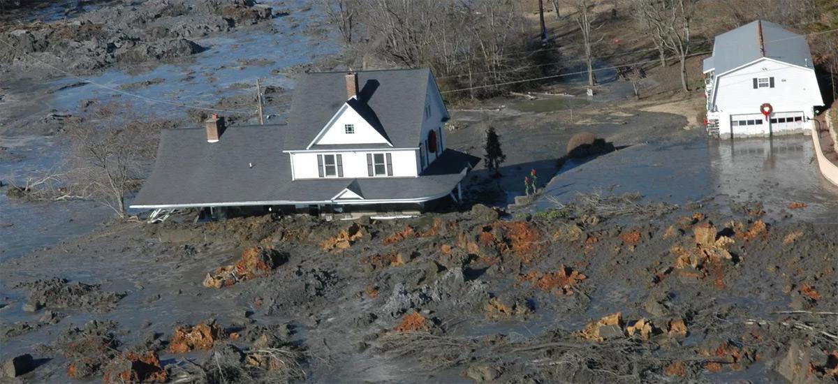 A house partly submerged in a coal ash spill